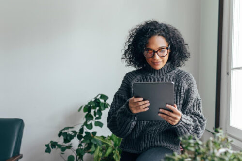 woman looks at tablet - becoming an agent with no experience